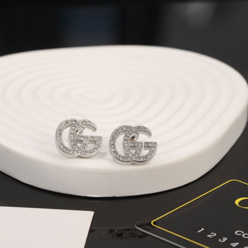 G*u*i earrings